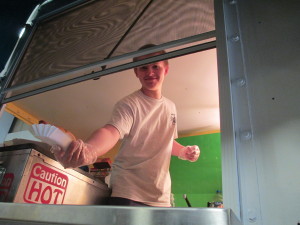 Dylan Chagnon serves a hot dog.