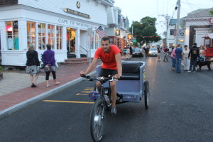 A pedicab in motion down Commercial Street.