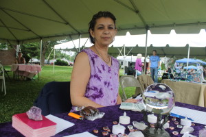 Gina Mitlo of Hudson with a crystal ball among other objects at the Psychic Fair.