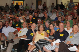 It was standing room only at the Cape Cod Commission subcommittee hearing about a proposal to build a Lowe's Home Improvement store in Dennis. Many wore yellow "No" stickers on their shirts to indicate their opposition.