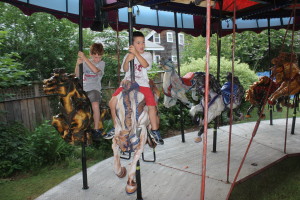 Henry, 8, and Noah, 6, go for a test ride on the carousel.