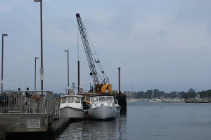 Some of the boats in the Falmouth oyster fleet are docked in Woods Hole.
