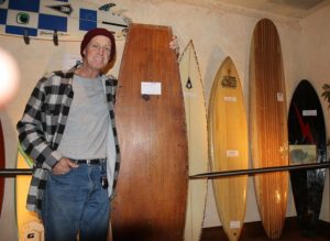 Barney Burrill with a plywood surf board made in 1965 by his uncle, George. "I was thinking it was cool, man. Way cool. I thought my cousin was the luckiest kid in the world."