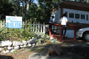 Volunteers with The Big Fix help to paint the handicapped ramp at Joan Avant's home. A turtle statue greets guests.