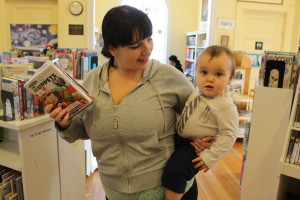 Jodi, with her son Max, picks out books to check out from Cotuit Library.