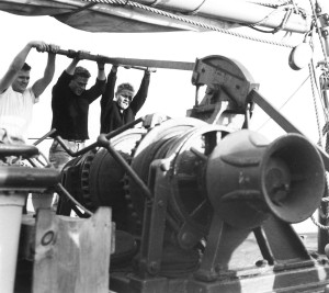 Bill Cooper, right, and other young crewmen work the anchor windlass on the "Atlantis."
