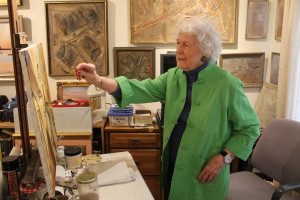 Marguerite Falconer at work on a canvas in her studio.