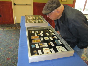 John McAndrews of Yarmouth examines the traveling examples of unclaimed property soon to be up for auction.