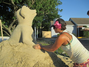 Professional sand sculptor, Morgan Rudluff of Santa Cruz, California, works on a piece for the Yarmouth Sand Castle Trail.