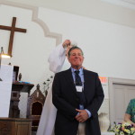 Rev. Fields baptizes Paul Rifkin, pouring a scallop shell of water on his head, while one of his sponsors, Elsie Jacobson, looks on. All photos LAURA M. RECKFORD/CAPE COD WAVE