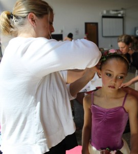 Photographs by LAURA M. RECKFORD. Danielle Sabens of Falmouth helps her daughter, Madeline, 9, get ready for the performance.
