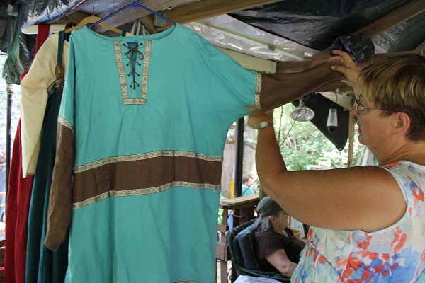 Elaine Sears-Dennehy, the group's seamstress, shows some of the tunics she's made.