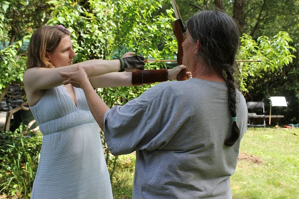 Archery expert Tanya Sanders teaches a newcomer how to shoot.