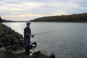 Brian Balliere of Douglas, MA, stops to fish at the Cape Cod Canal during what he called "the last hurrah" of the season.