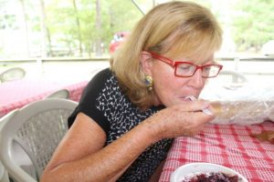 Carol Wilgus of Cotuit enjoys a piece of blueberry apple pie at the Autumn in Old Cotuit festival.