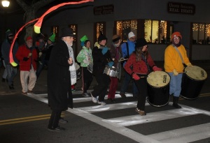 Al Moniz stops traffic on Main Street in Falmouth for a New Year's Eve procession.