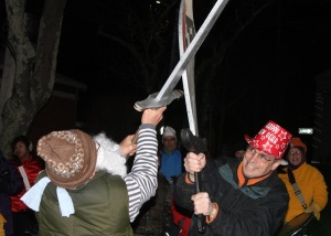 The old year and the new year, personified, battled with swords to the finish during a performance on Academy Lane.