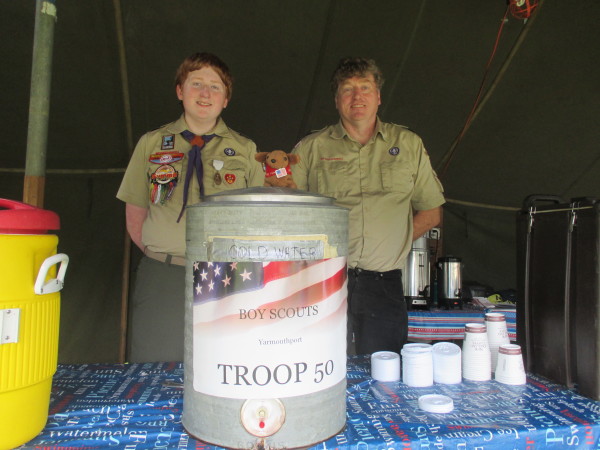 Alan Healy, 15, senior patrol leader for Troop 50 Yarmouthport, and his father, Kieran Healy, committee chairman for Troop 50, staff the wake-up tent at the rest area between exit 6 & 7 on eastbound Route 6.