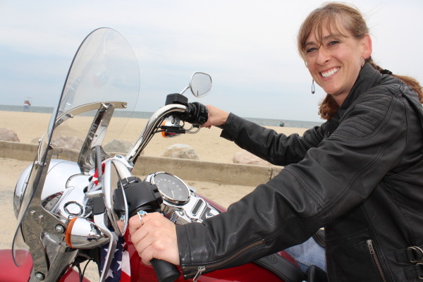 Cat Wilson on her red Harley