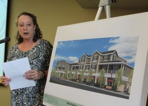 A consultant working for the developer who wants to build a Marriott in Falmouth stands next to a drawing of the proposed hotel.
