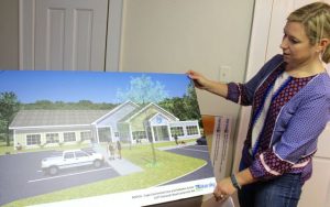 MSPCA--Cape Cod Campaign Director Laura Hay shows plans for the new building.