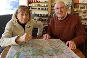 Barbara Weyand and Kevin Doyle take a break at Coffee Obsession with the Falmouth Preservation Alliance's new Heritage Map of Falmouth Village.