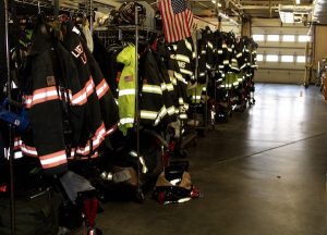 Firefighter uniforms stand ready for the next emergency.