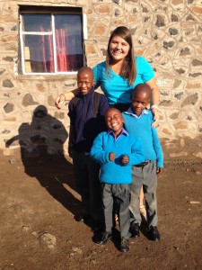COURTESY KARA HOWARD Kara Howard poses with her three younger brothers in her Lesotho family.