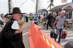 Provincetown Town Crier Ken Lonergan greets visitors to Provincetown as they arrive on the fast ferry from Boston.
