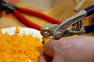 The tools of the trade include two-wheeled nipper to cut the glass.