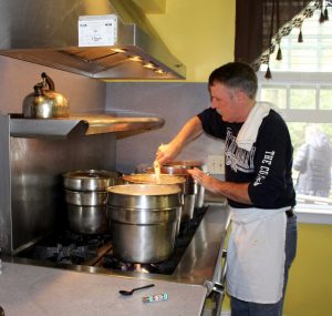 Jeff Lewis, owner of Seafood Sam's in Sandwich, prepares clam chowder for the event.
