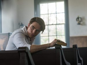 Robert Pattinson plays the Rev. Preston Teagardin in “The Devil All the Time.” (Netflix)