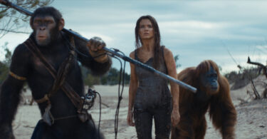 From left, Noa (Owen Teague), Mae (Freya Allan) and Raka (Peter Macon) appear in a scene from “Kingdom of the Planet of the Apes. Noa looks like a simian version of Mikey Day from “Saturday Night Live” while Raka looks like he stepped off the set of “Harry and the Hendersons.” (20th Century Studios)