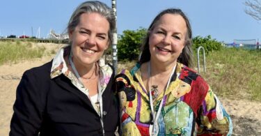 Jackie Reeves and Lauren Wolk in front of the iconic "Art" sign in Provincetown.